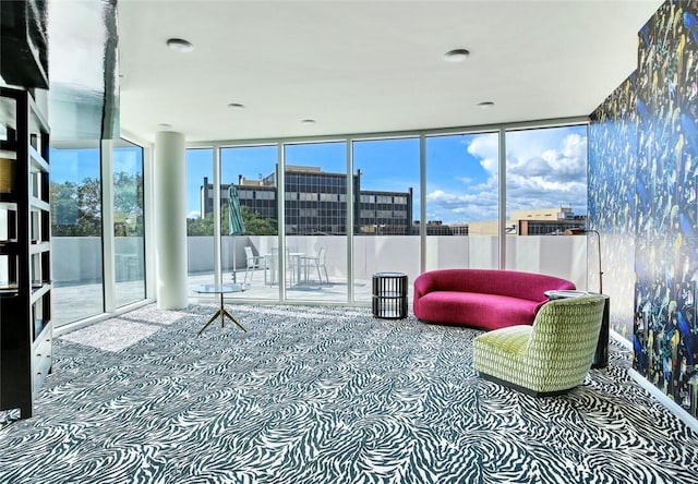 carpeted living room with a wall of windows