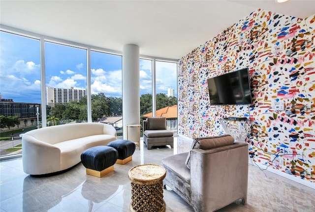 living room with tile patterned floors, a healthy amount of sunlight, and a wall of windows