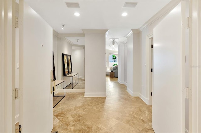 hall with crown molding, light tile floors, and ornate columns