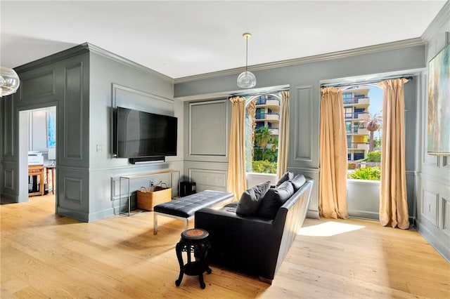 living room featuring ornamental molding and light wood-type flooring