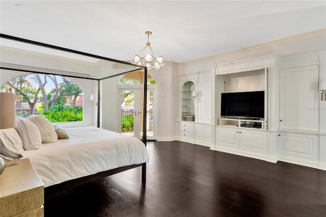 bedroom featuring a notable chandelier, access to exterior, french doors, ornamental molding, and dark wood-type flooring