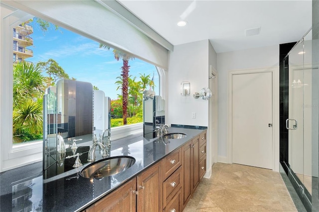 bathroom with oversized vanity, tile floors, a healthy amount of sunlight, and dual sinks