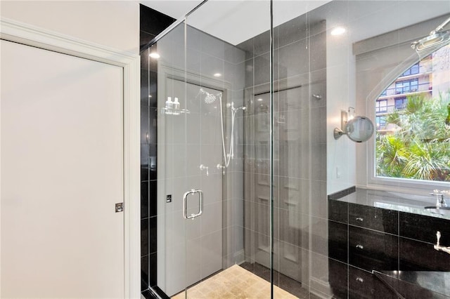 bathroom featuring a healthy amount of sunlight and a shower with shower door