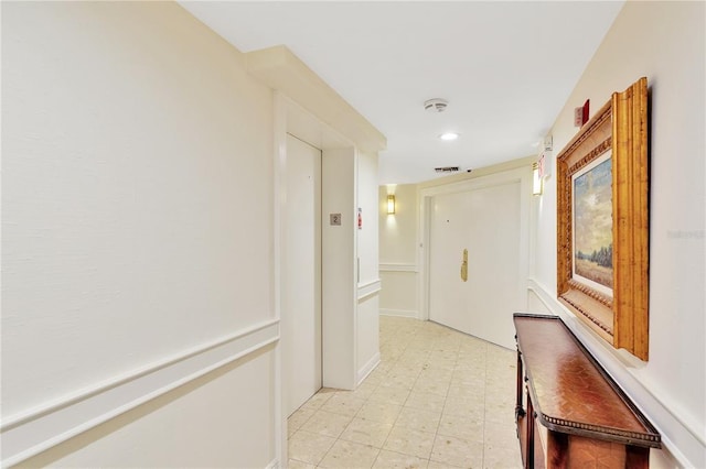 hallway featuring light tile floors