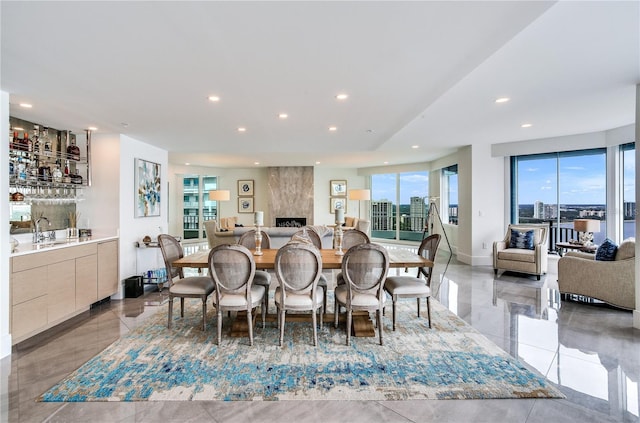 dining space featuring a premium fireplace and indoor wet bar