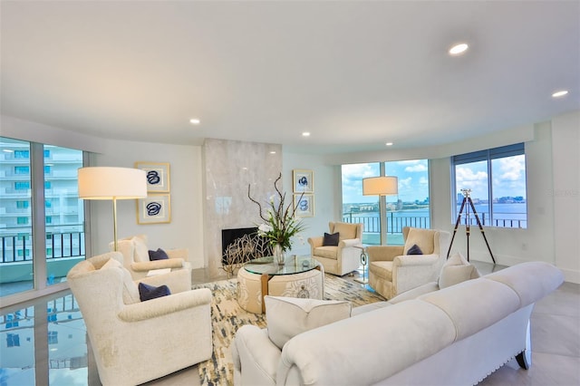 living room featuring a water view and a fireplace