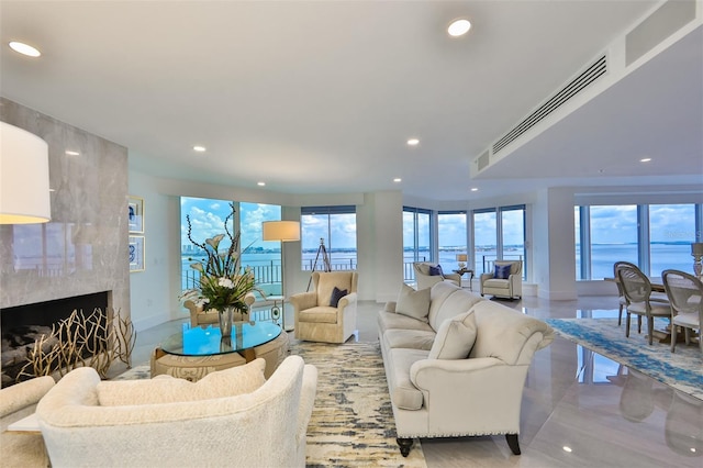 living room featuring a water view and a fireplace