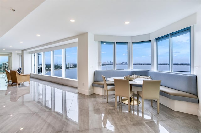 dining area featuring breakfast area and a water view