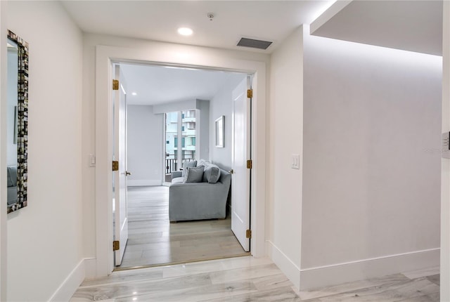 hall with light hardwood / wood-style flooring