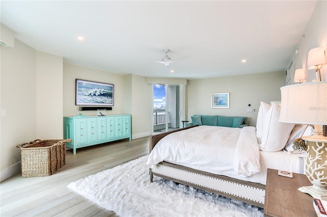 bedroom featuring light hardwood / wood-style flooring, ceiling fan, and access to outside