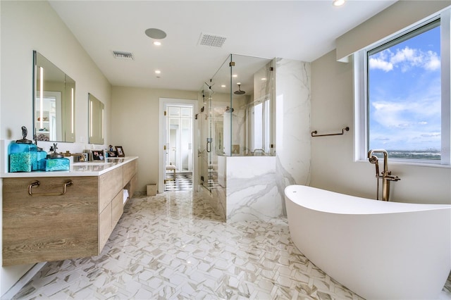 bathroom featuring vanity and separate shower and tub