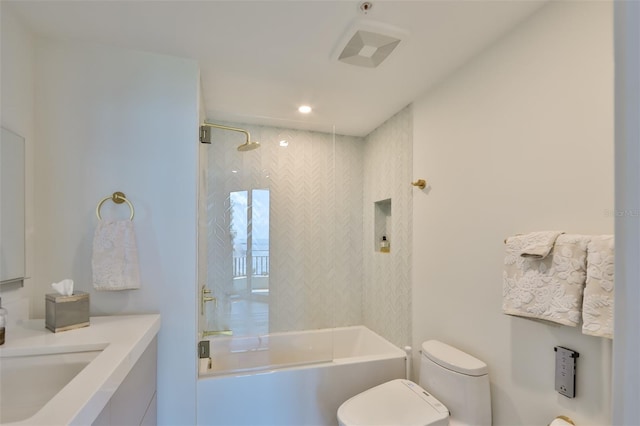 full bathroom featuring vanity, toilet, and tiled shower / bath combo