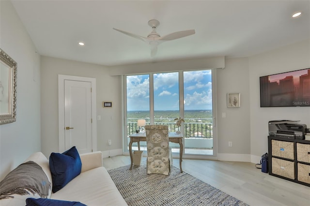 living room featuring ceiling fan and light wood-type flooring