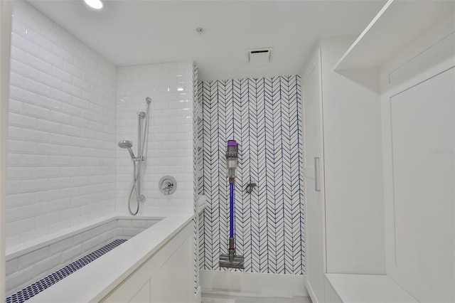 bathroom with tiled shower