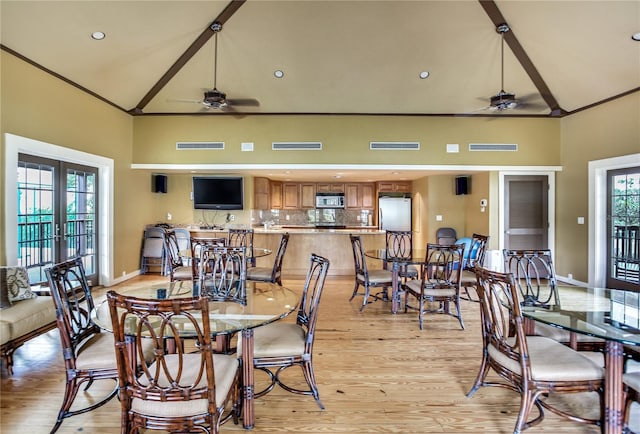 dining space featuring crown molding, ceiling fan, high vaulted ceiling, french doors, and light wood-type flooring