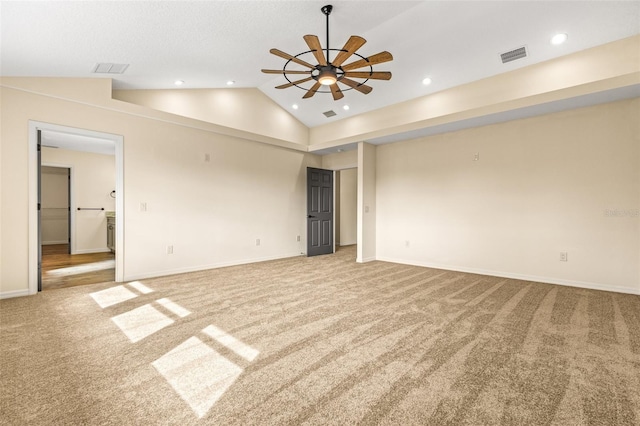 unfurnished room featuring light colored carpet, lofted ceiling, and ceiling fan