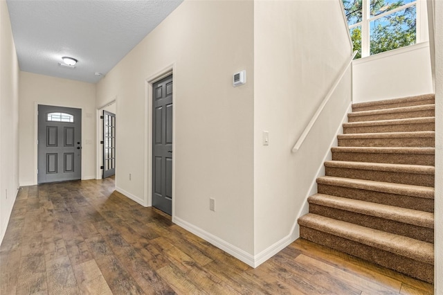 foyer featuring a textured ceiling and hardwood / wood-style flooring