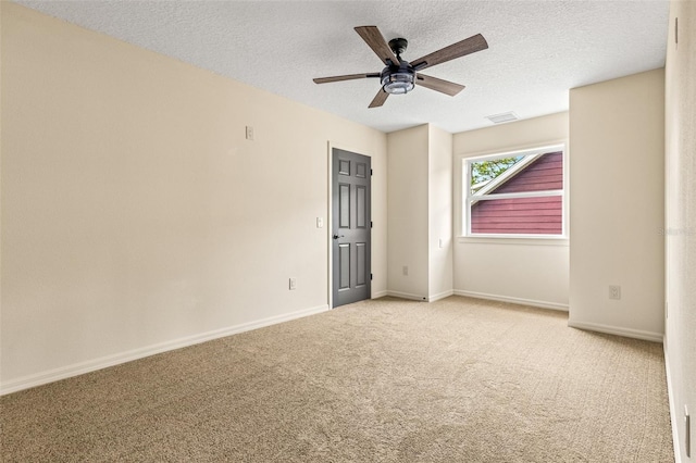 carpeted empty room with a textured ceiling and ceiling fan