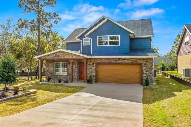 craftsman-style house featuring a garage, cooling unit, and a front lawn