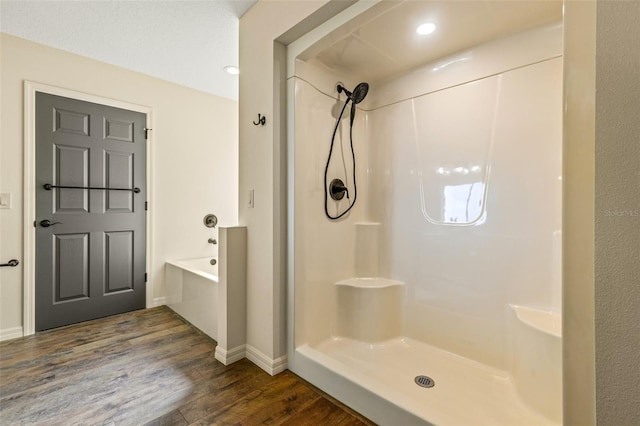 bathroom with wood-type flooring and separate shower and tub