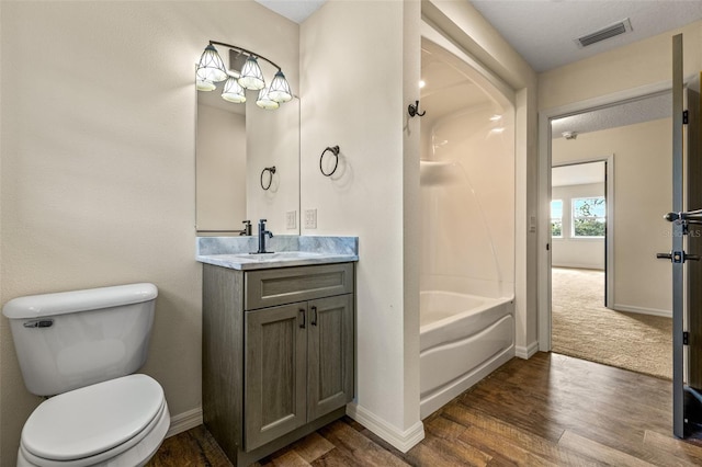 full bathroom featuring toilet, tub / shower combination, vanity, and hardwood / wood-style floors