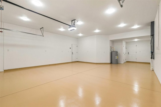 garage featuring electric water heater and a garage door opener