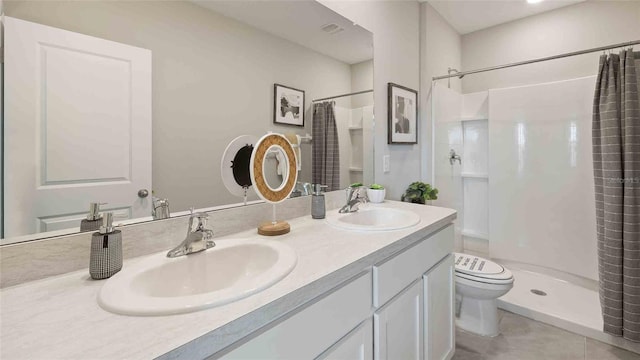 bathroom with tile patterned floors, vanity, a shower with shower curtain, and toilet