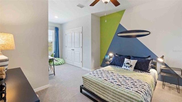 carpeted bedroom featuring a closet and ceiling fan
