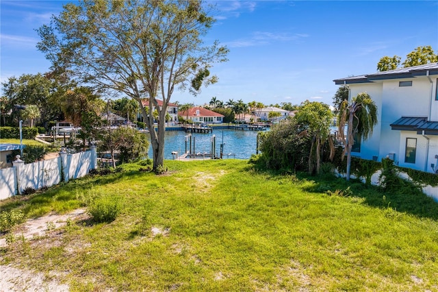 view of yard with a water view and a boat dock