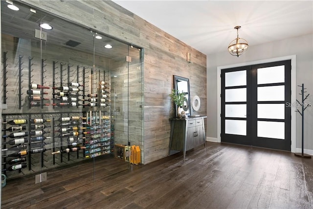 wine room featuring dark hardwood / wood-style floors and a chandelier