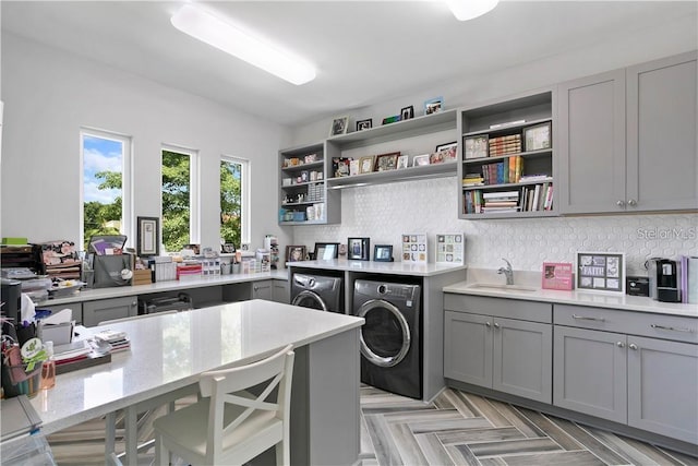 laundry room featuring washer and clothes dryer, sink, and light parquet flooring