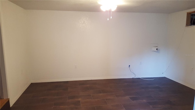 spare room featuring dark hardwood / wood-style floors and ceiling fan