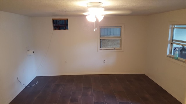 spare room featuring ceiling fan and dark wood-type flooring