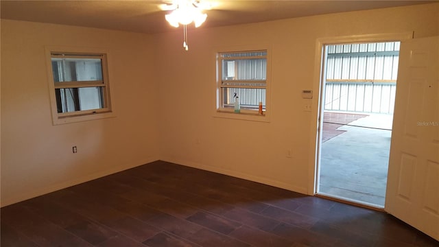 unfurnished room with dark hardwood / wood-style floors and ceiling fan