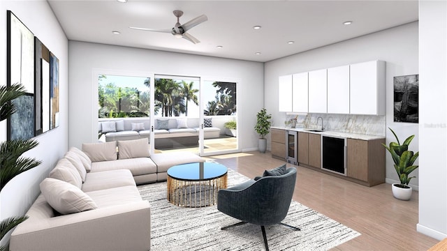 living room featuring light hardwood / wood-style floors, sink, ceiling fan, and beverage cooler