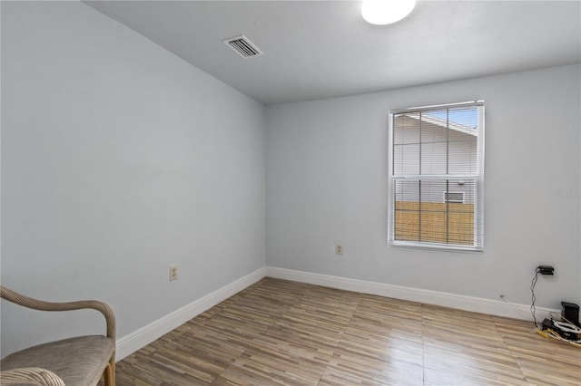 empty room with light hardwood / wood-style floors