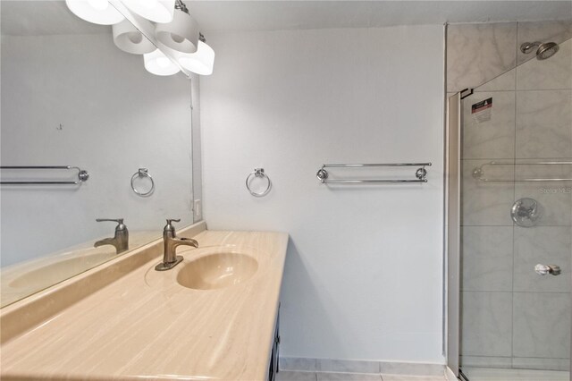 bathroom with vanity and tiled shower