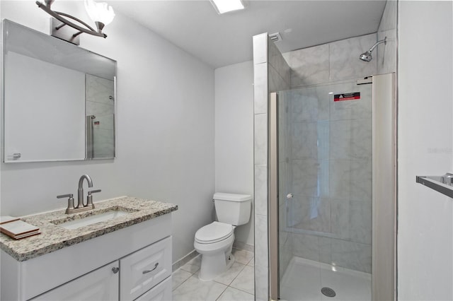 bathroom featuring vanity, tile patterned flooring, a shower with door, and toilet