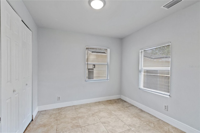 spare room featuring light tile patterned floors