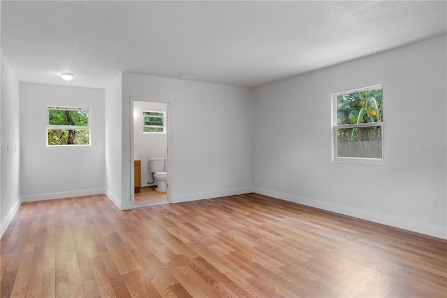 empty room with light hardwood / wood-style flooring