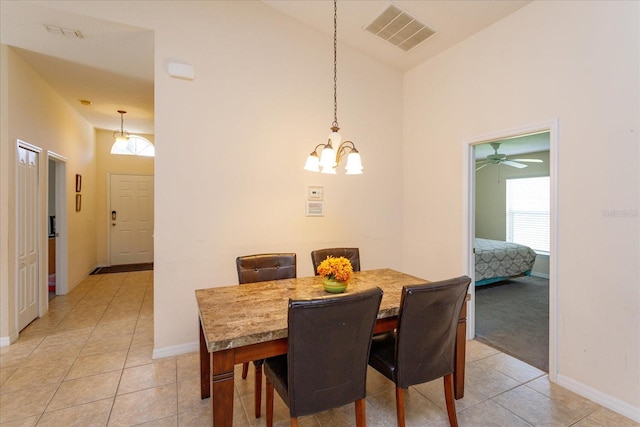 dining area featuring light tile patterned flooring and high vaulted ceiling