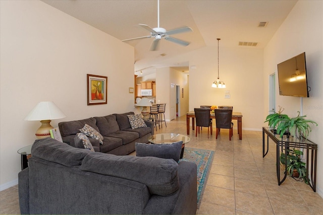 living room with light tile patterned floors, high vaulted ceiling, and ceiling fan