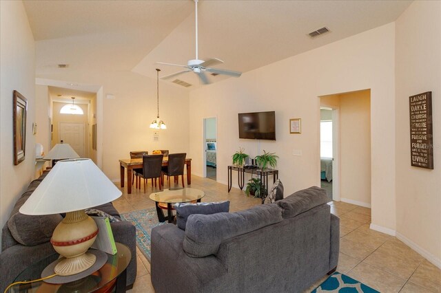 tiled living room featuring vaulted ceiling and ceiling fan