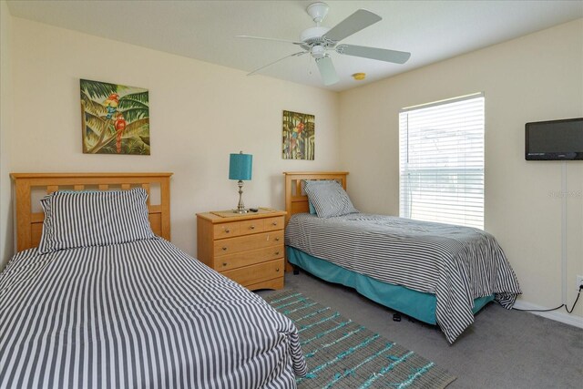 bedroom with ceiling fan and carpet flooring