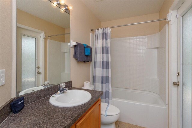 full bathroom with vanity, shower / tub combo with curtain, tile patterned floors, and toilet