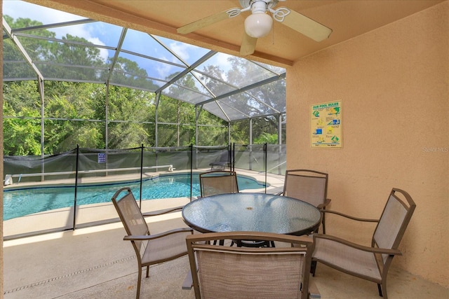 view of pool featuring ceiling fan, a lanai, and a patio area