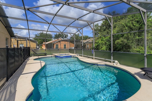 view of pool with an in ground hot tub and a lanai