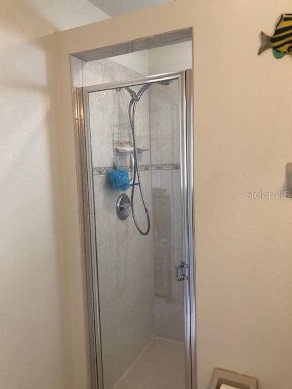 bathroom with a shower with door