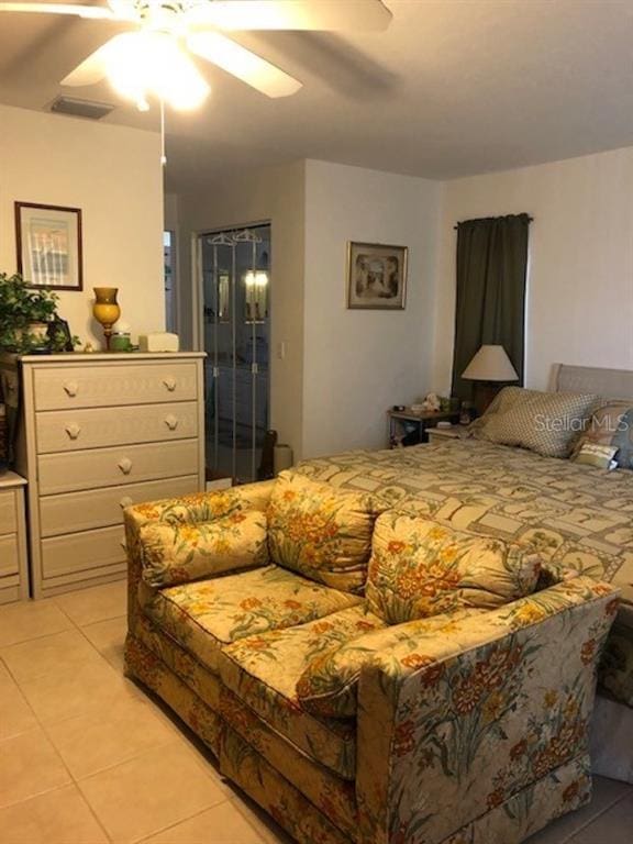 tiled bedroom with ceiling fan