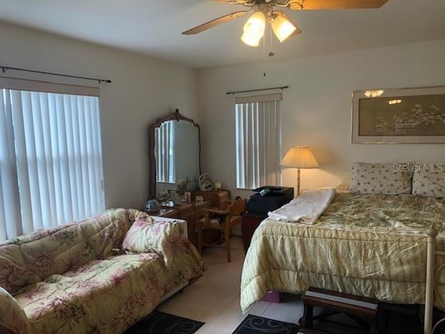 bedroom with light tile floors and ceiling fan